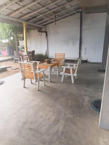a group of tables and chairs in a patio at Ocean beach in Galle