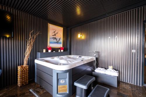 a bathroom with a sink and two stools at 216 Castle Hotel in Gebze
