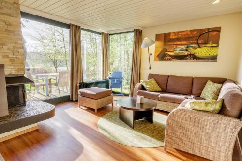 a living room with a couch and a fireplace at Center Parcs Bispinger Lüneburger Heide in Bispingen