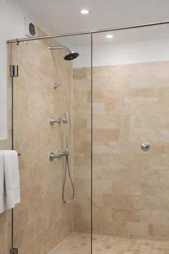 a shower with a glass door in a bathroom at At Villa Fig Guest House in Constantia