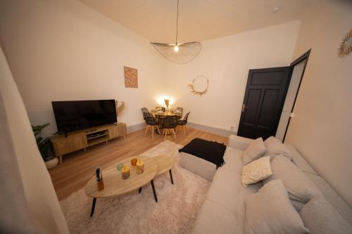 a living room with a couch and a table at L'Élégance - Cozy & Parking in Chambéry