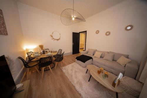 a living room with a couch and a table at L'Élégance - Cozy & Parking in Chambéry