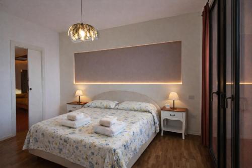a bedroom with a bed with two night stands and two lamps at Corina's Place Bologna Home in Bologna