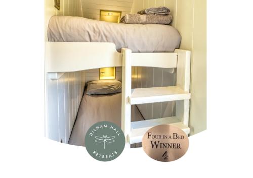 a room with a bunk bed and a sign that reads fauna bar winner at Dilham Hall Retreats in Dilham