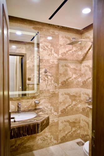 a bathroom with a sink and a mirror at Executive 2BHK in Zeta Mall in Islamabad