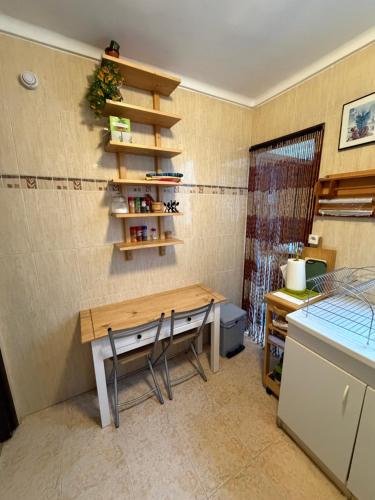 a kitchen with a desk and a table and chairs at RIU MAR Apartment Cullera in Cullera