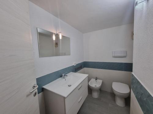 a bathroom with a white sink and a toilet at Tortuga Smeralda in Porto Rotondo