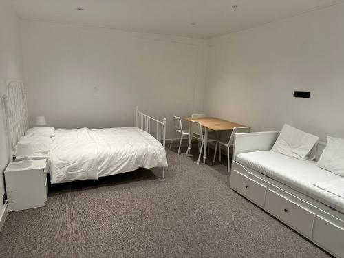 a bedroom with a bed and a couch and a table at شقة رقم 1 in An Najaf