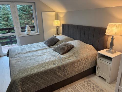 a bedroom with a bed with two pillows on it at Mazurska Riwiera in Dabrowa