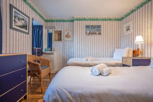 a hotel room with two beds and a desk at Stoneywell Cottage - Elie in Elie