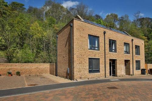 a brick building sitting on the side of a road at Beautiful City Centre House with Parking! Sleeps 6 in Sheffield