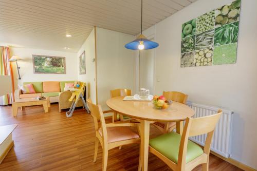 a dining room with a table and chairs at Center Parcs Bispinger Lüneburger Heide in Bispingen