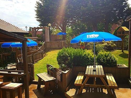 a patio with a table and an umbrella at The Stockton Arms in Stockton-on-Tees