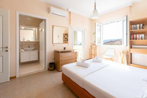 a bedroom with a bed and a bathroom with a sink at Chios Seafront Luxury Villa with Pool in Chios