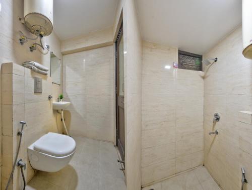 a bathroom with a toilet and a sink and a shower at Hotel Maharani -New Delhi Railway Station - Paharganj in New Delhi