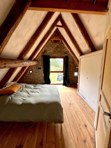 a bedroom with a bed in a attic at La grange du Taillat in Campan