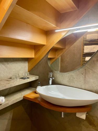 a bathroom with a white sink and a mirror at Suites du Cabinet Vert in Orléans