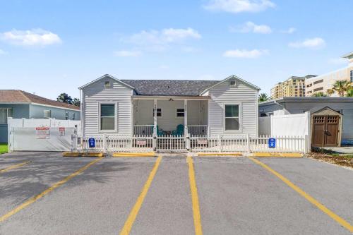 a house with a white fence in a parking lot at East Shore Paradise #448 in Clearwater Beach