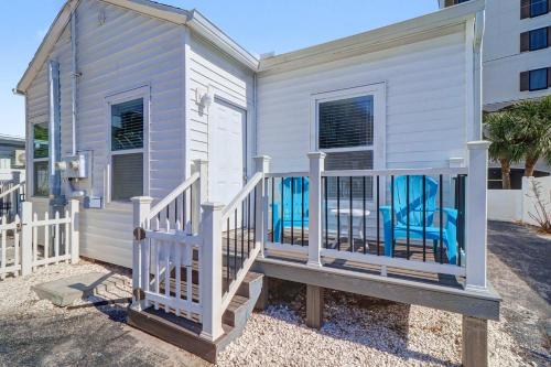 a house with a porch with blue chairs on it at East Shore Paradise #448 in Clearwater Beach