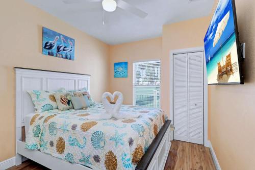 a bedroom with a bed with a heart on it at East Shore Paradise #448 in Clearwater Beach