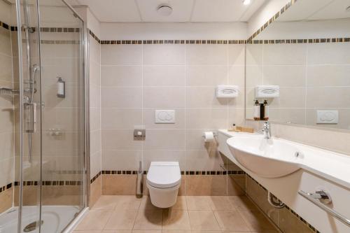 a bathroom with a toilet and a sink and a shower at Perla, Resort & Entertainment in Nova Gorica