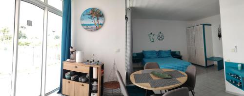 a small room with a table and a bed at TOUMALACAÏ Appart 238 in Folle Anse
