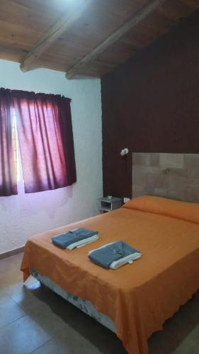 a bedroom with a bed with two towels on it at Soñada San Rafael in San Rafael