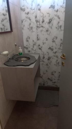 a bathroom with a sink and a wall at Soñada San Rafael in San Rafael