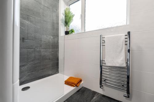 a white bathroom with a shower and a sink at Cosy Anfield Home in Liverpool