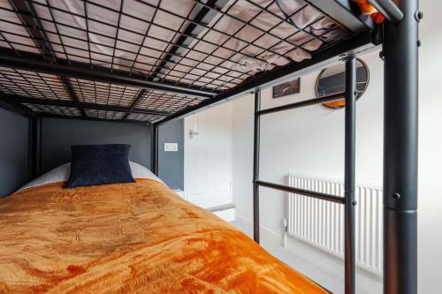 a bedroom with a bed with a blue pillow on it at Cosy Anfield Home in Liverpool