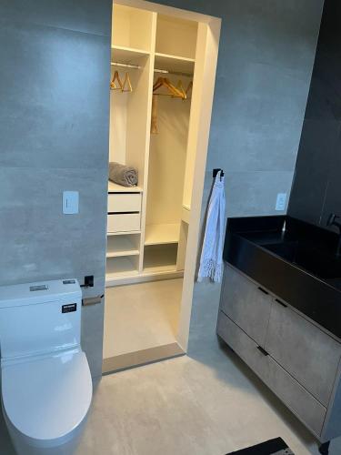 a bathroom with a white toilet and a sink at Angra casa in Angra dos Reis