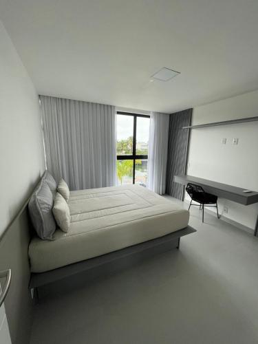 a bedroom with a large bed and a window at Angra casa in Angra dos Reis