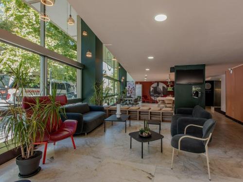 a lobby with couches and chairs in a store at B&B Hotel Firenze City Center in Florence