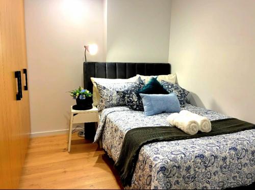 a bedroom with a bed with pillows and a table at Bliss in Braddon in Braddon