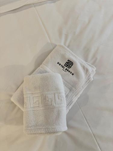 a pair of white socks sitting on a bed at Hotel Bravo Iasi in Iaşi
