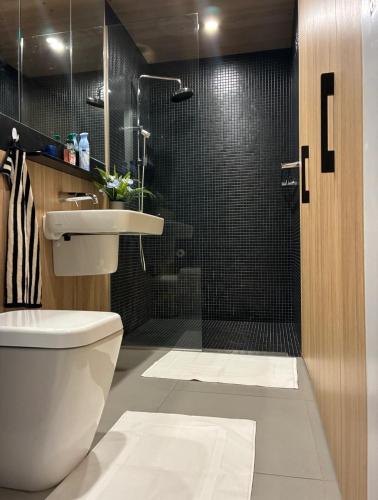 a bathroom with a toilet and a sink and a shower at Bliss in Braddon in Braddon