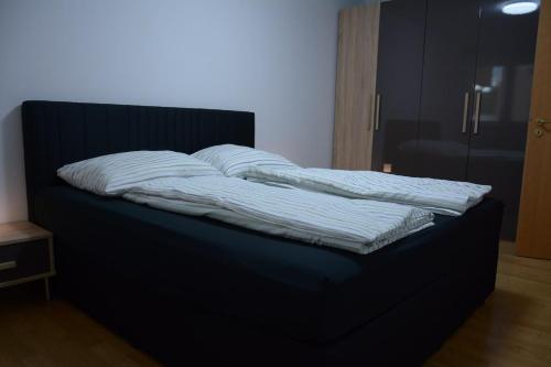 a bed with two pillows on top of it at Exklusive Wohnung mit Garten in Niederdorla