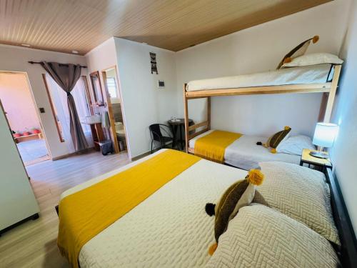 two beds in a room with two bunk beds at Casa Ñawi in San Pedro de Atacama