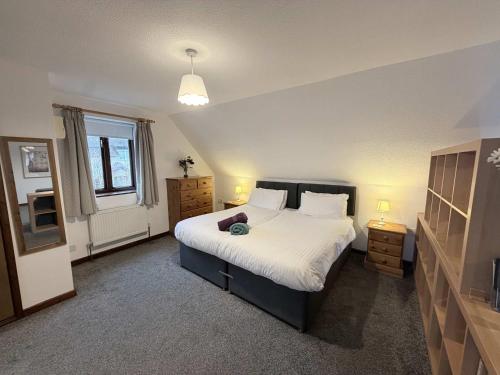 a bedroom with a large bed with white sheets at Millbrook House Apartments 2 in Milton