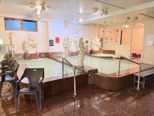 a museum with a swimming pool with statues in it at Capsule Hotel Sauna G -topia male Only in Funabashi
