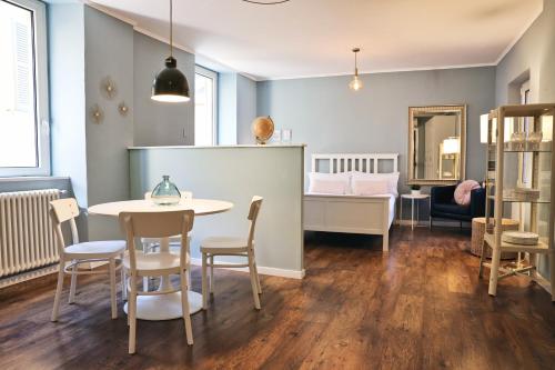 a room with a table and chairs and a bedroom at Varennahouse in Varenna