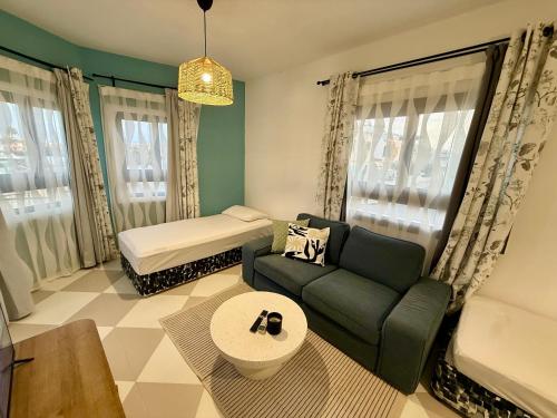a living room with a couch and a bed at Olivia One Bedroom Apt renovated 2026 in Paralimni