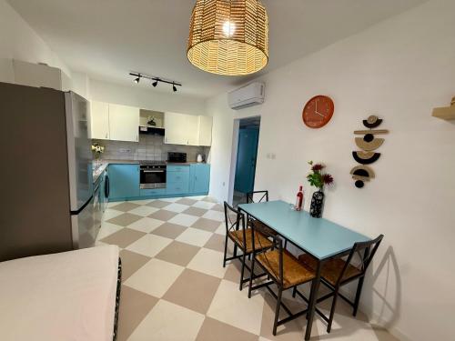 a kitchen and dining room with a table and chairs at Olivia One Bedroom Apt renovated 2026 in Paralimni