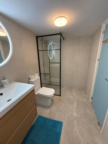 a bathroom with a toilet and a sink and a shower at Olivia One Bedroom Apt renovated 2026 in Paralimni