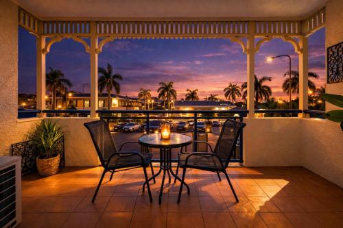 a patio with a table and chairs on a balcony at Perfect Position for City and Stadium Access Townsville in Townsville