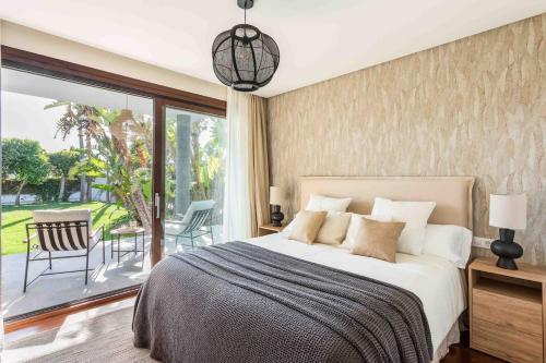 a bedroom with a large bed and a balcony at A paradise with ocean views in Conil de la Frontera