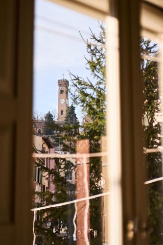 a view of a clock tower from a window at Boutique Apartment nel Borgo - Casa Olga e Casa Ilde - Le Dimore del centro in Santarcangelo di Romagna