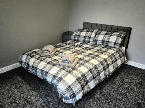 a bedroom with a bed with two pillows on it at Cog Lane House in Burnley