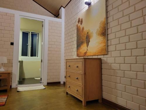 a room with a dresser and a painting on the wall at Stay Zen in Arangala
