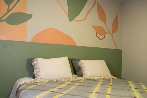 a bed with two pillows in a bedroom at Seu Refúgio em Cuiabá in Cuiabá